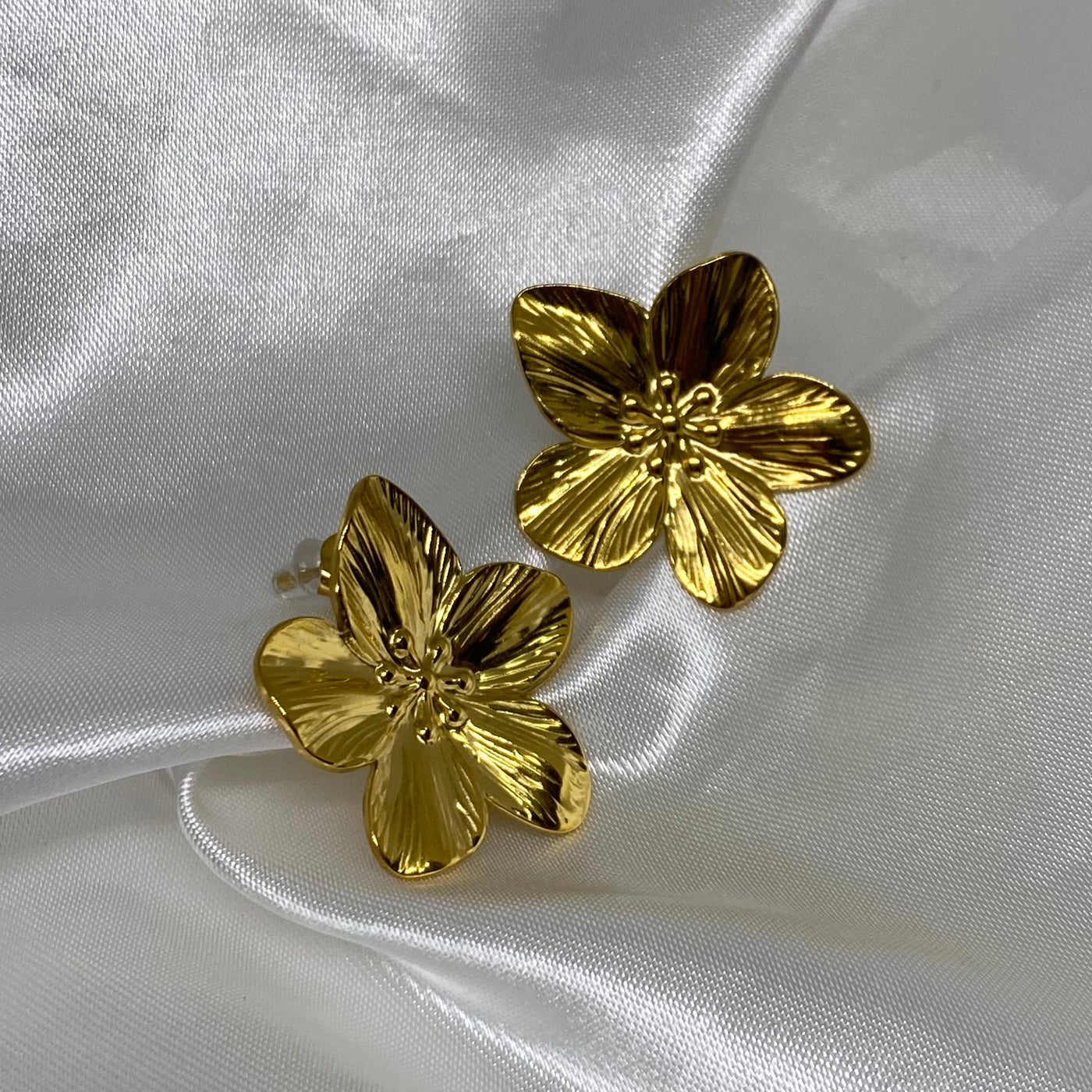 Aretes Marjorie en forma de flor de acero inoxidable con baño de oro de 18 K.